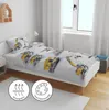 A child's bed with bedding featuring a construction vehicle print, set in a bedroom with a window and curtains. Produktbild-Vorschau