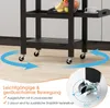 A close-up view of the wheels and lower part of a black kitchen cart, with text and diagrams highlighting its mobility features. Náhled obrázku produktu