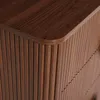 A close-up view of the corner of a wooden dresser or cabinet, showing the ribbed texture of the side and the smooth top surface. Podgląd zdjęcia produktu