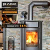 A stove with a fan on top, in a room with a stone wall and stacked wood. Produktbild-Vorschau
