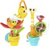 Two bath toys, a flower and a snail, are shown against a white background. Water is splashing around them. Podgląd zdjęcia produktu
