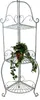 A silver metal corner shelf unit with a potted plant on one of the shelves. Podgląd zdjęcia produktu