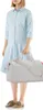 A woman stands holding a duffel bag. Produktbild-Vorschau