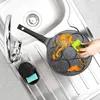A person is cleaning a multi-mold frying pan in a kitchen sink. Produktbild-Vorschau