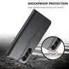 A black flip phone case is shown diagonally on a cracked surface with a circular inset showing the camera lenses and a graphic indicating shock absorption. Produktbild-Vorschau