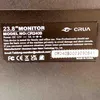 A close-up of a label on the back of a monitor, showing product information and certifications. Produktbild-Vorschau