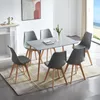 A dining room scene with a table and chairs. Voir les images du produit