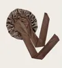 A brown satin bonnet with long ties, laid flat against a light beige background. Podgląd zdjęcia produktu