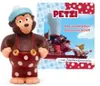 A toy figure of a monkey character named Petzi, standing next to a book cover featuring the same character and a ship. Produktbild-Vorschau
