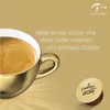 A golden coffee cup filled with coffee, next to a coffee capsule, with marketing text and intensity rating. Produktbild-Vorschau