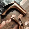 Two copper faucets are shown on a textured background with hexagonal tiles. Anteprima dell’immagine prodotto