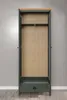 An open wardrobe with a wooden interior and a single drawer at the bottom, set against a plain gray wall. Podgląd zdjęcia produktu