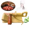 A wooden slicer with a sausage and sliced cucumbers, with a chef in the background. Náhled obrázku produktu