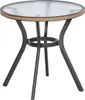 A round outdoor table with a glass top and a woven edge, supported by a dark metal frame with three legs. Produktbild-Vorschau