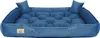 A blue velvet dog bed with two small pillows on a white background. Voir les images du produit