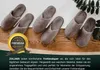 Several pairs of brown slippers are arranged on a wooden surface with some greenery in the background. A circular badge with text is overlaid on the left side. Produktbild-Vorschau
