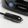 Close-up of a black car power adapter plug connected to a black appliance with a Dometic logo and a blue power button. Produktbild-Vorschau