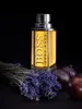 A bottle of Hugo Boss The Scent perfume is displayed with lavender and figs against a black background. Náhľad obrázku produktu