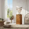 A cozy living room with boho-chic decor, featuring a wooden pedestal, macrame wall hanging, hanging chair, and plants. Voir les images du produit