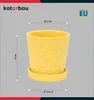 A yellow ceramic pot with a saucer, shown with dimensions indicated by lines and text. Náhľad obrázku produktu