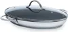A stainless steel frying pan with a glass lid and two handles, shown from a slightly elevated side angle against a white background. Produktbild-Vorschau