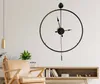 A modern living room with a large wall clock, a chair, and a console table. Voir les images du produit