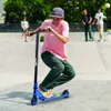 A young person riding a scooter in a skate park. Náhľad obrázku produktu