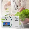 An ozone generator is shown in use, with a person washing lettuce under a faucet. Náhled obrázku produktu