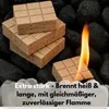 Several fire starters are stacked on top of each other, with one in the foreground lit and burning, surrounded by charcoal. Produktbild-Vorschau