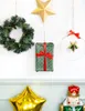 Christmas decorations hanging on a wall, including a wreath, a wrapped gift, and star ornaments, with balloons and a nutcracker figure at the bottom. Náhled obrázku produktu