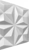 A close-up, angled view of a white 3D wall panel with a geometric, faceted design. Produktbild-Vorschau