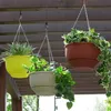 Three hanging planters with plants are shown suspended from a wooden pergola. Podgląd zdjęcia produktu
