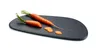 Two carrots and carrot slices on a black cutting board. Anteprima dell’immagine prodotto
