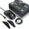 A gaming mouse and its accessories are displayed on a white background, with the product packaging in the background. Produktbild-Vorschau