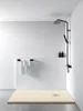A modern, minimalist bathroom shower area with a beige shower tray and black fixtures. Produktbild-Vorschau