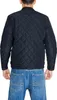 A person wearing a black quilted jacket and blue jeans, shown from the back. Produktbild-Vorschau