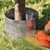 A metal ring around the base of a tree trunk, with a lawnmower in the foreground. Produktbild-Vorschau