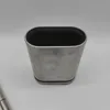 A silver toilet brush holder with a black interior is shown against a white background. Produktbild-Vorschau