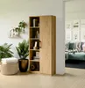 A wooden bookshelf with books and plants in a living room setting. Produktbild-Vorschau