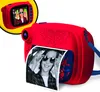 A red instant print camera with a Spider-Man theme, printing a black and white photo of a child wearing sunglasses. Voir les images du produit