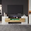 A modern TV stand with integrated LED lighting, displaying a television and decorative items. Náhľad obrázku produktu