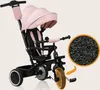 A pink multifunctional tricycle and stroller for children, shown with a close-up inset of its wheel material. Produktbild-Vorschau