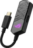 A close-up studio shot of a black ASUS ROG Clavis AI Noise Cancelling Mic Adapter. Podgląd zdjęcia produktu