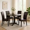 A dining set with four chairs around a round table in a room with natural light. Produktbild-Vorschau