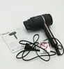 A black Beurer hair dryer with rose gold accents is shown on a white background, along with its instruction manual and a small safety warning sticker. Podgląd zdjęcia produktu