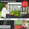 A woman tending to lettuce in a raised garden bed with a greenhouse-like structure. Produktbild-Vorschau