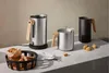 A collection of kitchen appliances and bread on a countertop. Anteprima dell’immagine prodotto