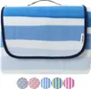 A folded picnic blanket with blue and white stripes. Náhled obrázku produktu