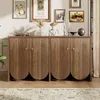 A wooden sideboard with fluted doors and gold handles, decorated with artwork and decorative items on top, in a room setting. Podgląd zdjęcia produktu