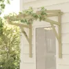 A wooden pergola-like structure with ivy growing on it, attached to the side of a house above a door. Podgląd zdjęcia produktu